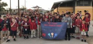 Students stand with their Red Ribbon Week banner